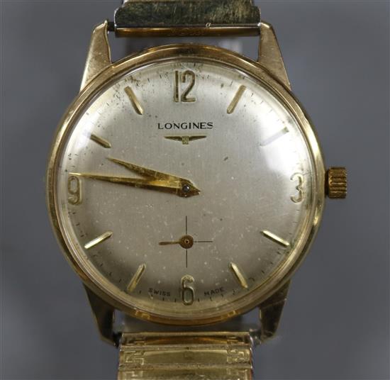 A gentlemans 9ct gold Longines manual wind wrist watch, on associated flexible strap,